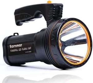 A compact and durable black portable spotlight with a powerful LED beam, designed for illuminating campsites, hiking trails, and aiding in emergency situations during nighttime.