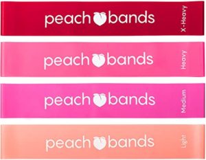 Four resistance bands labeled "peach bands." Each band is a different shade of pink, indicating varying resistance levels: X-Heavy (dark red), Heavy (dark pink), Medium (pink), and Light (light pink).