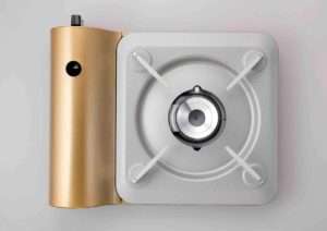 A compact silver portable butane stove with a single burner and sturdy base, designed for easy outdoor use. Ideal for cooking while camping, picnics, or during emergencies.