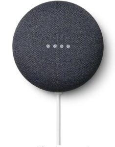 A Google Nest Mini, a small, circular smart speaker with a fabric-covered top. It has four white LED lights in the center, indicating it is active or listening. The device is connected to a power source via a white cable at the bottom.