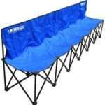 A set of portable sports benches with blue seats and metal frames, arranged on a grassy field. Each bench accommodates several players and can be folded for easy transport and storage.
