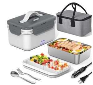 A set of portable food warmers including a gray and white electric lunch box, a gray insulated carrying bag, a stainless steel food container with a meal, a divided food tray with fruits and yogurt, a fork, a spoon, and power cables.